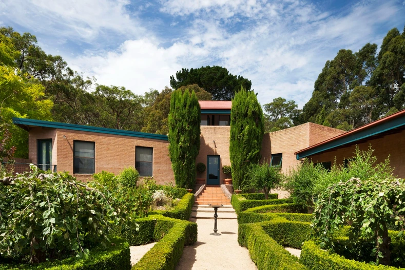 The Merli family home, with brick walls and teal roof detailing